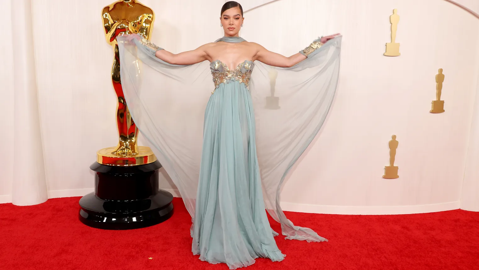 Hailee Steinfeld wears a sheer pale blue gown.