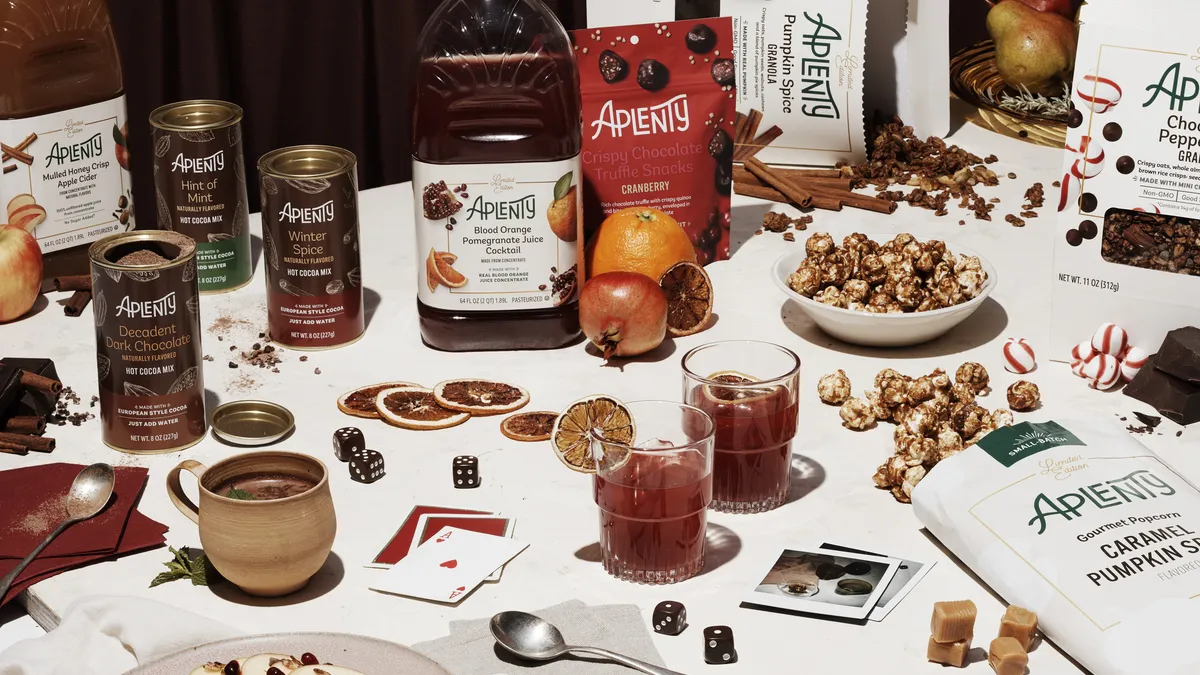 A table filled with holiday food and drink items, including blood orange pomegranate juice and crispy chocolate truffle snacks.