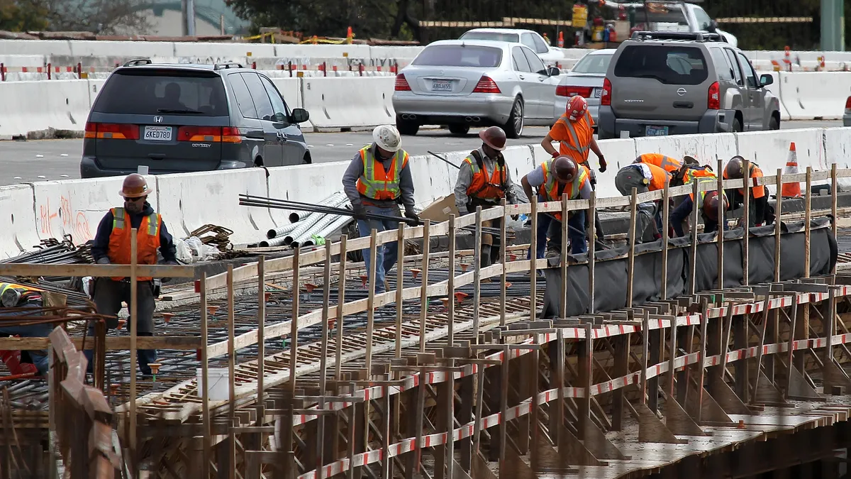 Construction crews work on a freeway overpass along Highway 101 on March 26, 2012 in Novato, California.