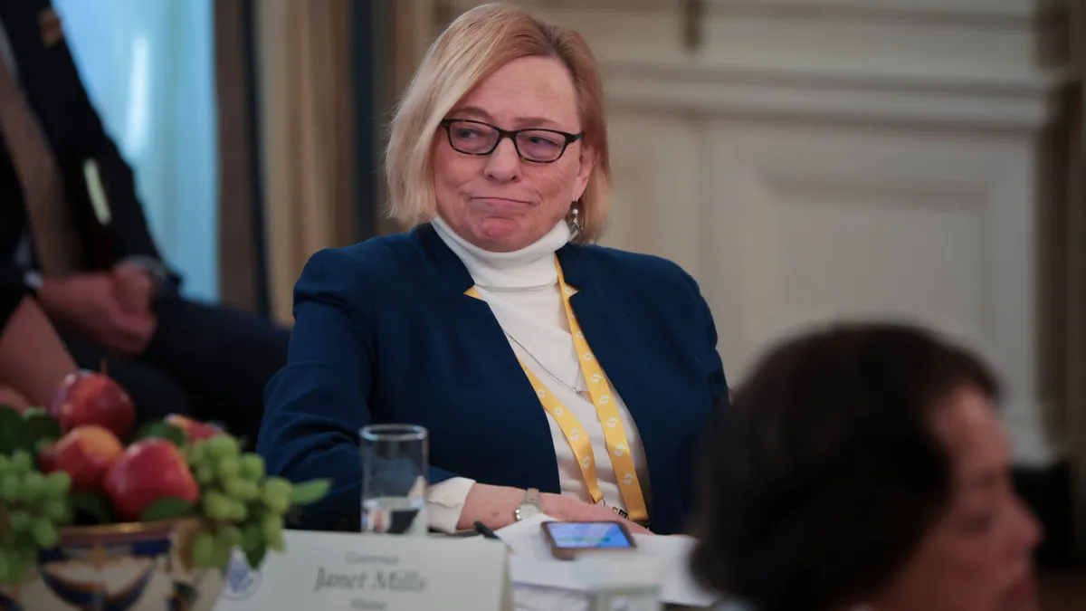 Janet Mills sits at a table at the White House during a governors meeting with President Donald Trump.