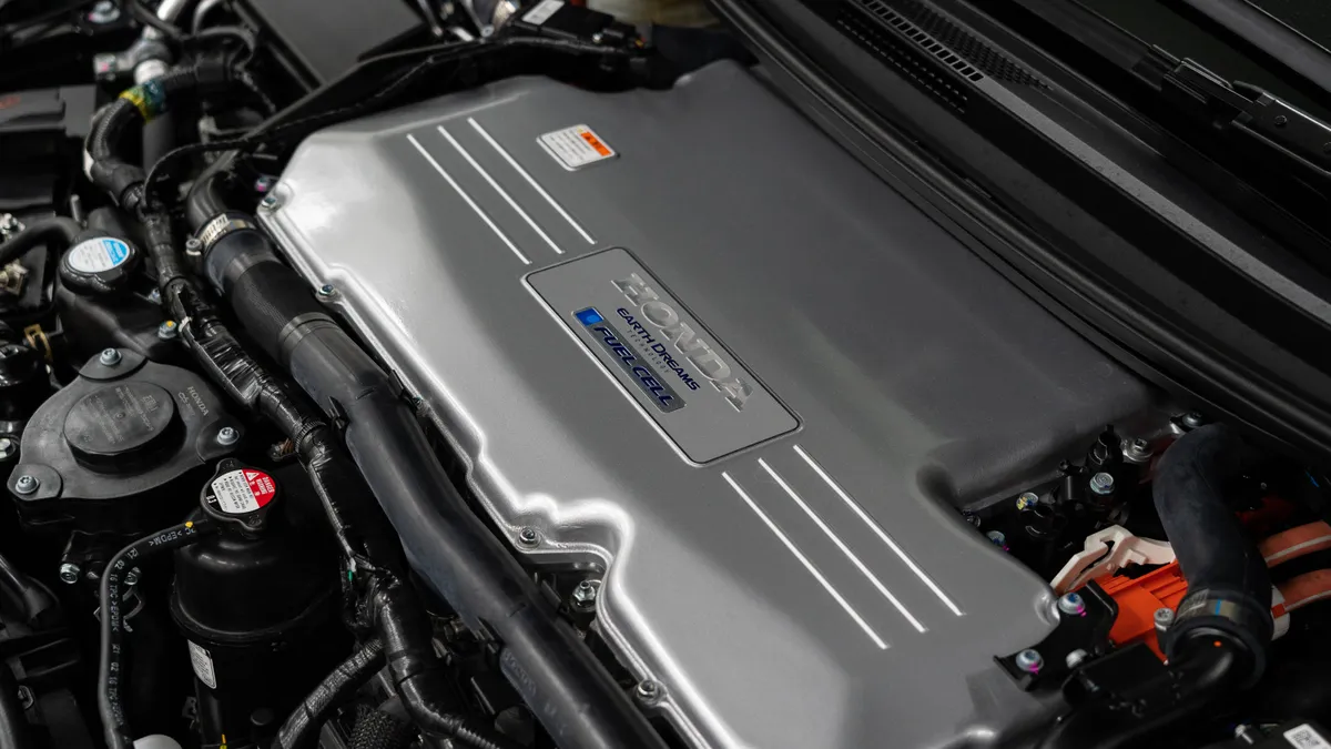 Close-up under the hood of a future Honda vehicle, with a large gray component marked "Fuel Cell."