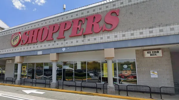 Exterior of a grocery store with a red sign that says "Shoppers."