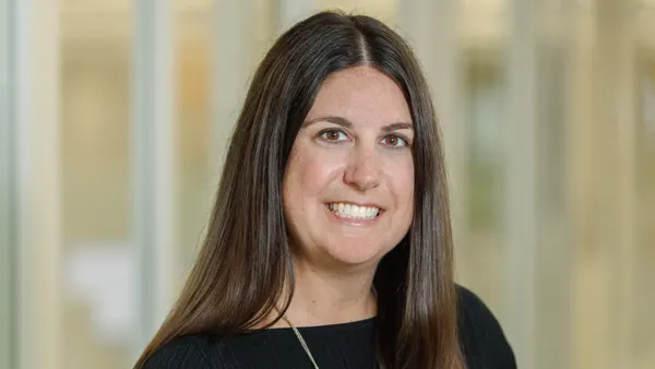 A portrait photo of a smiling woman wearing black.