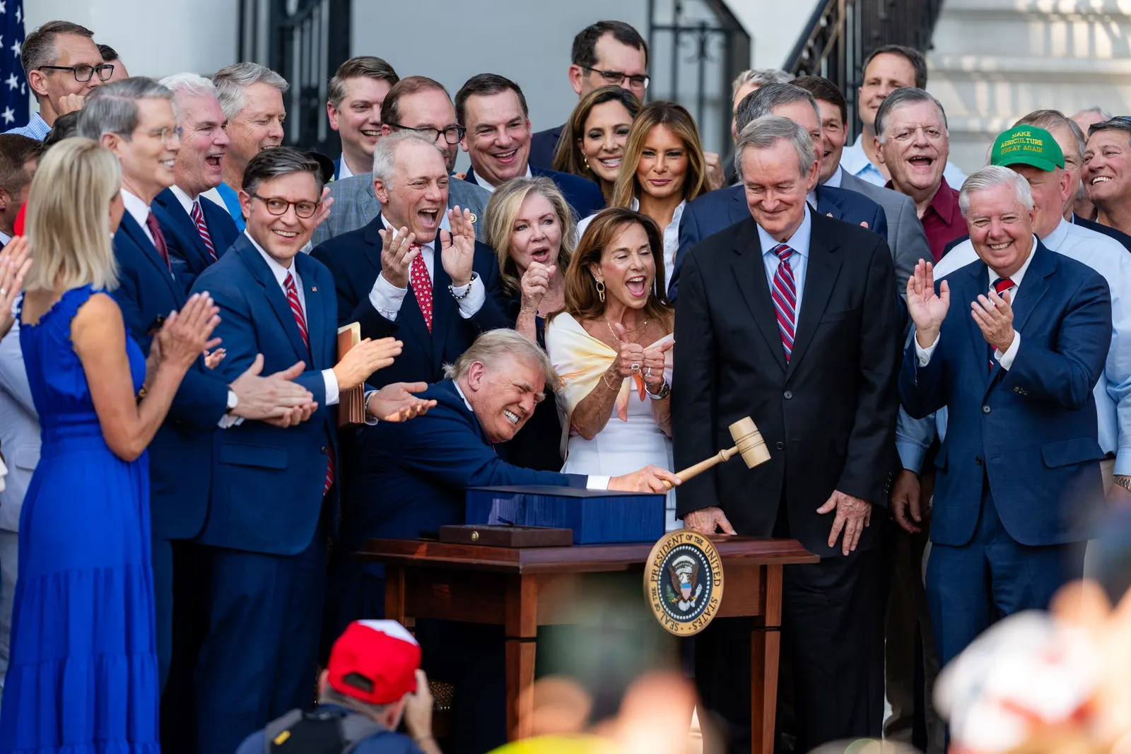 President Donald Trump, joined by Republican lawmakers, holds a gavel after signing the One, Big Beautiful Bill Act into law