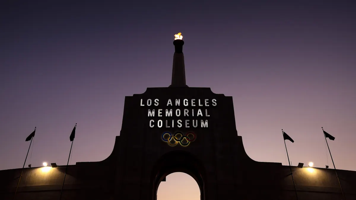 A flame atop the Los Angeles Memorial Coliseum at night.