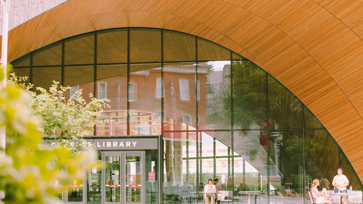 A few students sit outside Temple University's library.