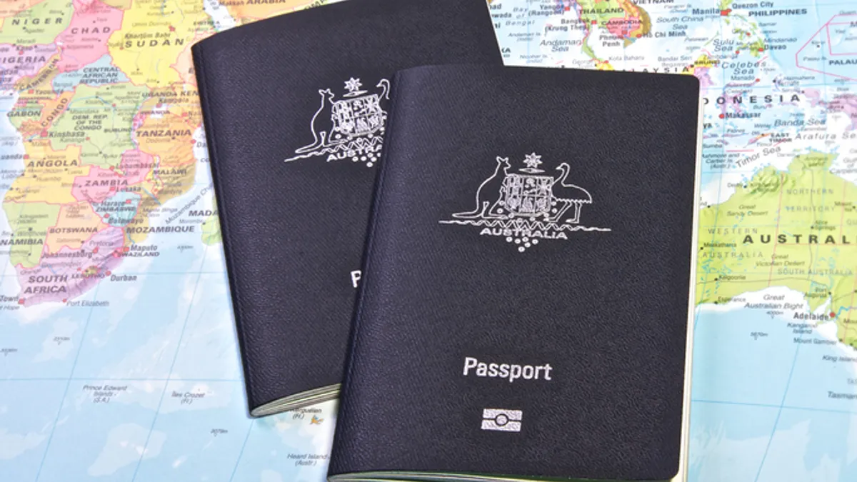 Australian passport with the world map in the background