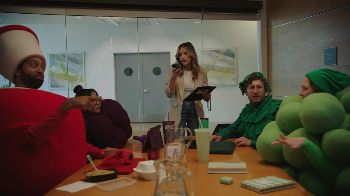 Fruit of the Loom's fruit mascots sit around a conference table with the brand's "chief TikTokker"