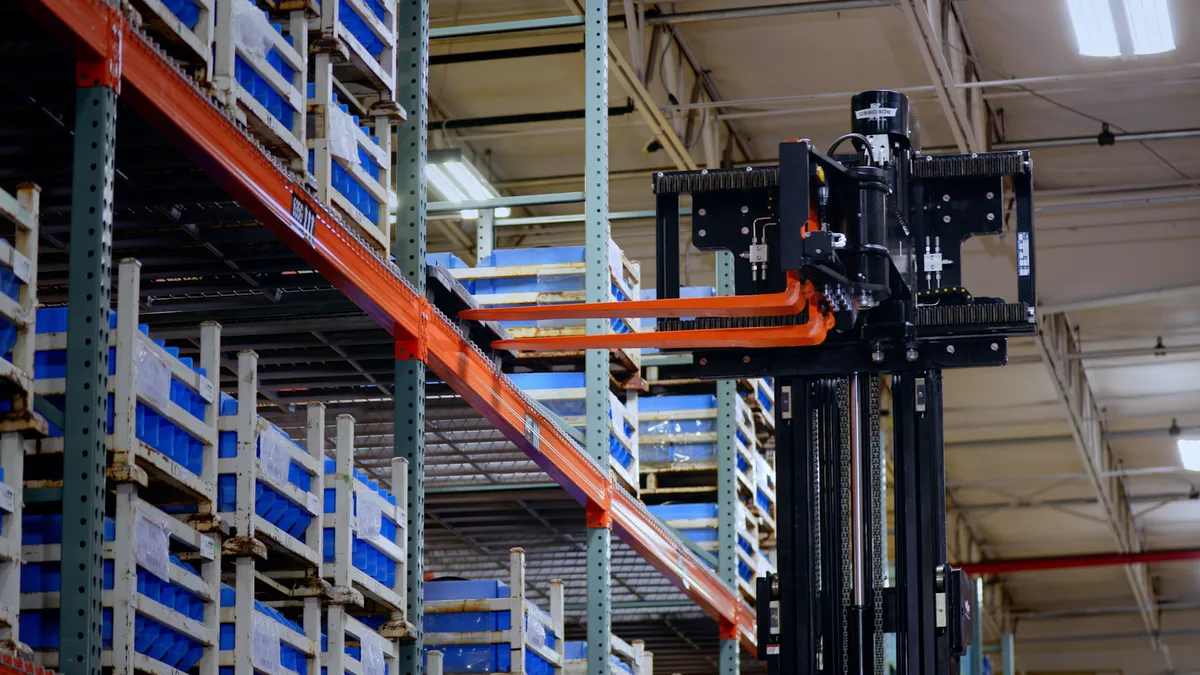 Toyota forklift being used in warehouse to move pallet.