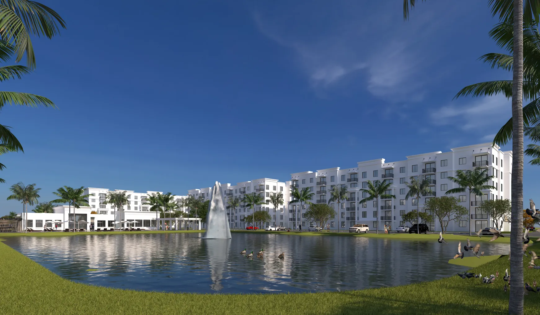 White mid-level apartment property with a lake in the foreground.