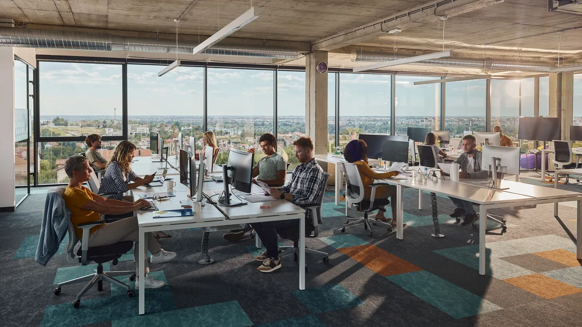 A group of workers at an office desk.