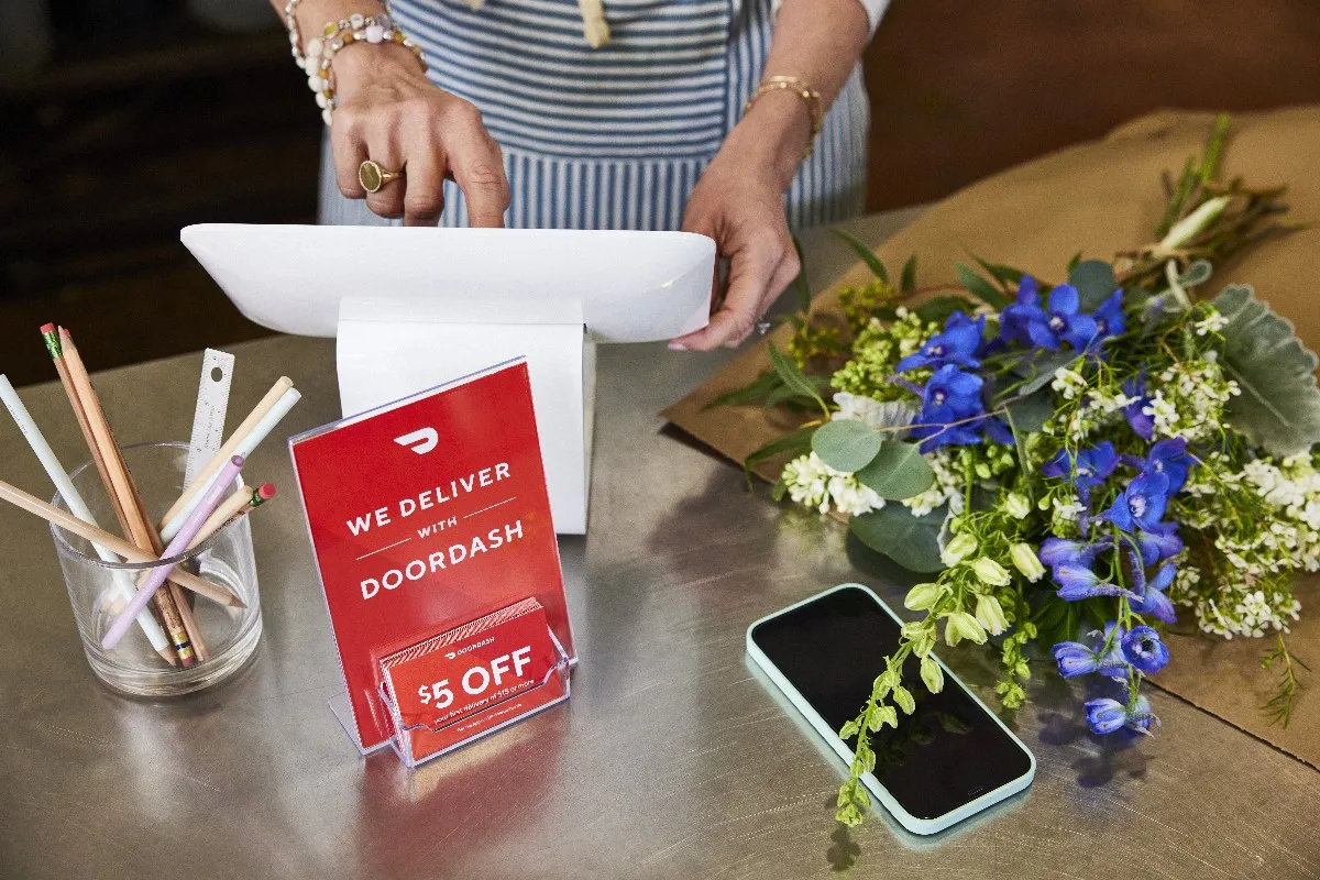 An image of a countertop with flowers and a DoorDash logo