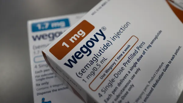 Two prescription drug cartons are seen stacked on top of each other, bearing the word Wegovy.