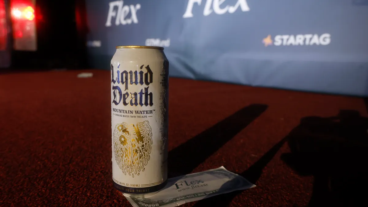 A can of Liquid Death water is displayed with a tip underneath it