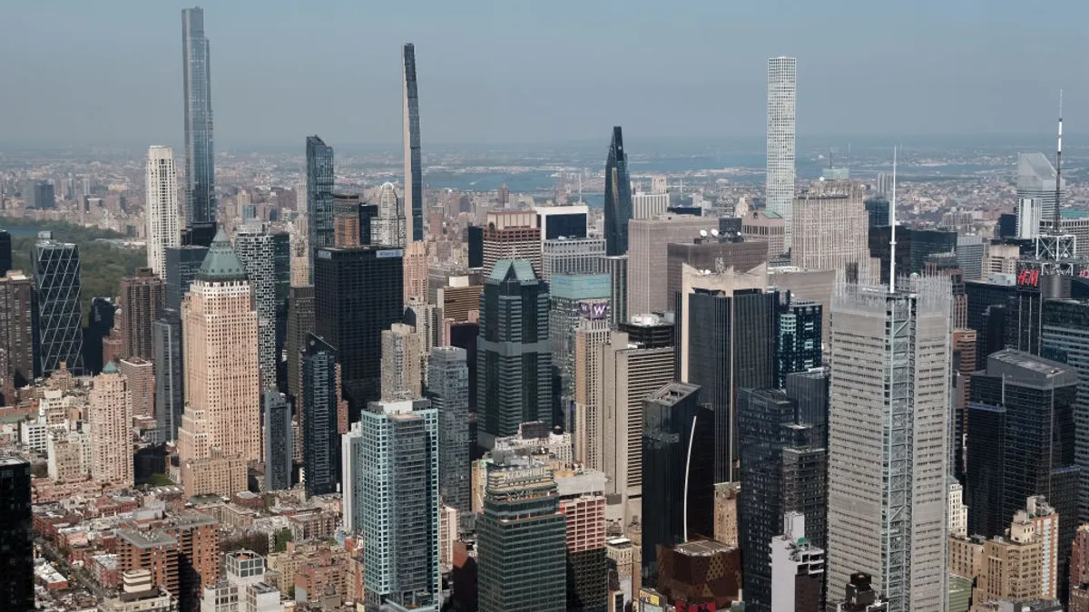 A dense urban skyline with multiple tall apartment buildings.