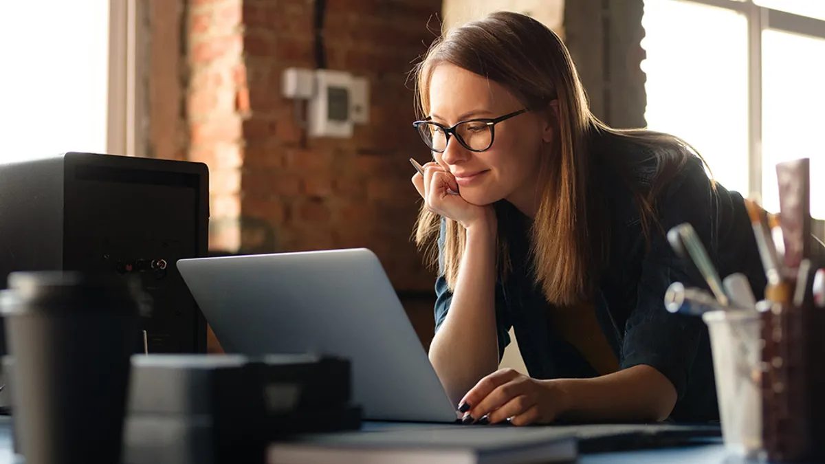 A girl works at a computer in a modern office