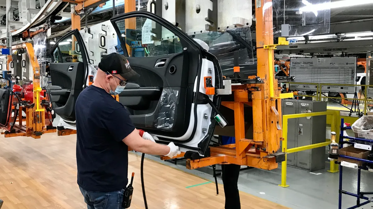 Stellantis employees assembling doors.