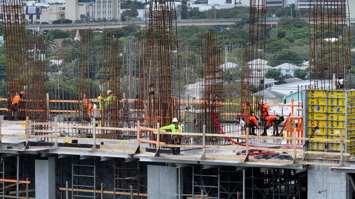 In an aerial view, construction workers build a residential building on January 5, 2024 in Miami, Florida.