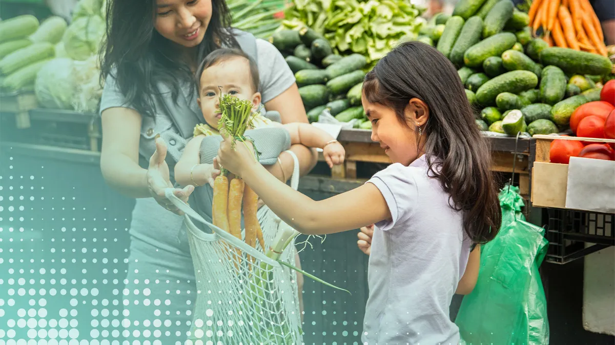 Mother and her children grocery shopping for vegetables.