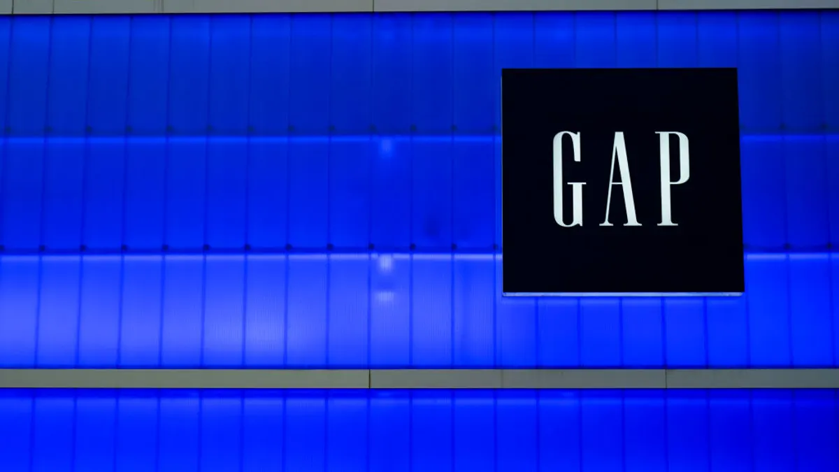 A storefront sign titled "Gap" sits against a blue window background