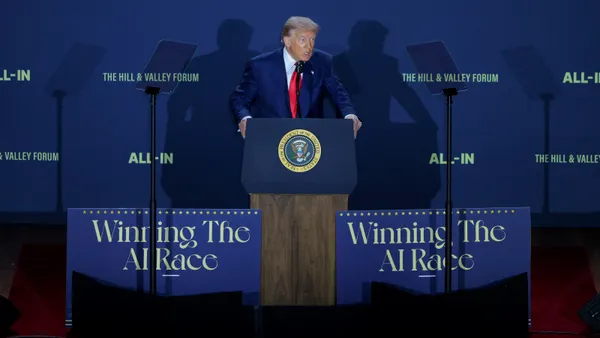 A man speaks at a podium.