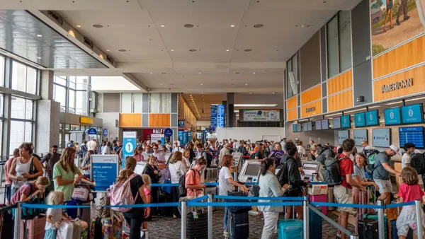Travelers stand in line at the Austin-Bergstrom International Airport in Austin, Texas.