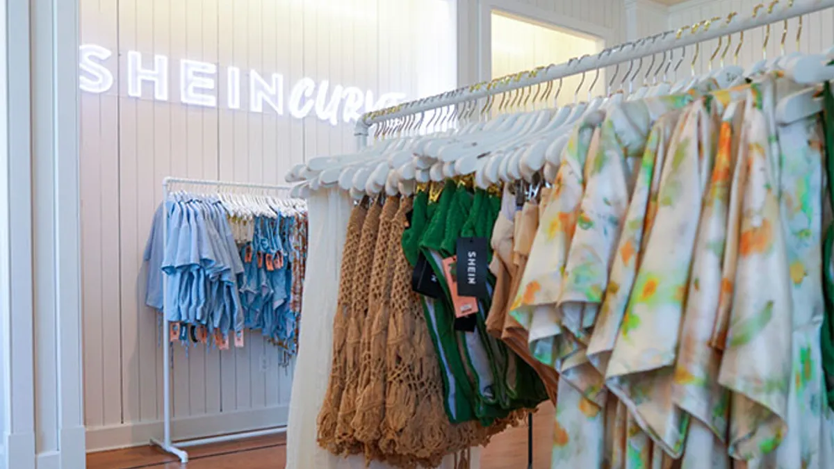 A Shein store is pictured, with a rack of clothes on display.