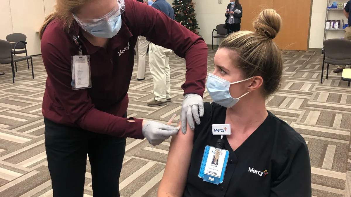 Jessica Bingley, an emergency room nurse in St. Louis, is among the first to receive a COVID-19 vaccine in the region on Monday, Dec. 14, 2020.