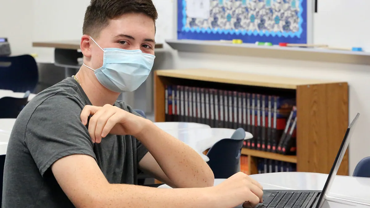 A high school students returns to school during the pandemic.