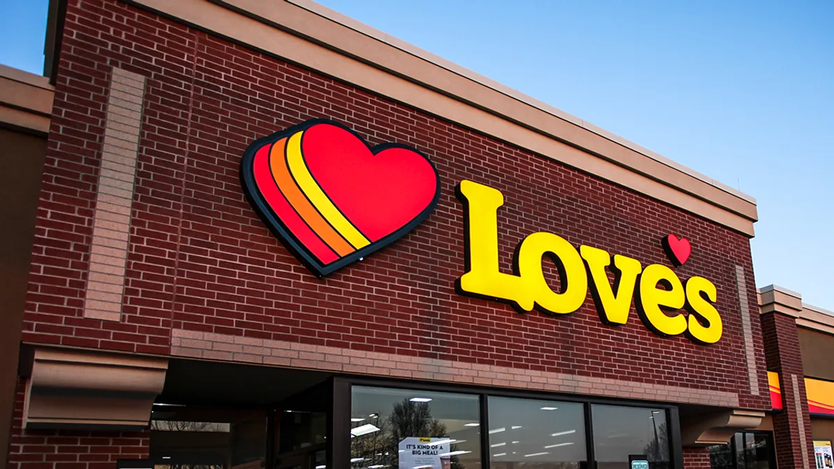 A photo of a Love's Travel Stops & Country Stores sign on a building.