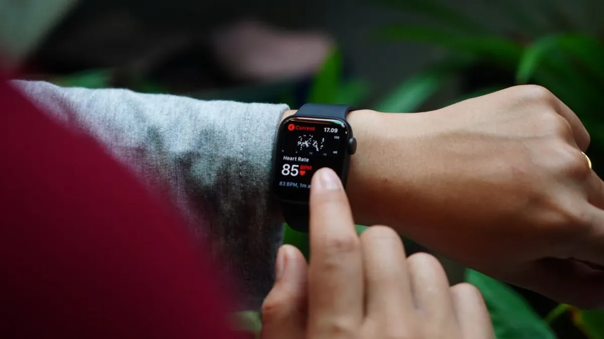 Male sitting on down looking at wrist watch