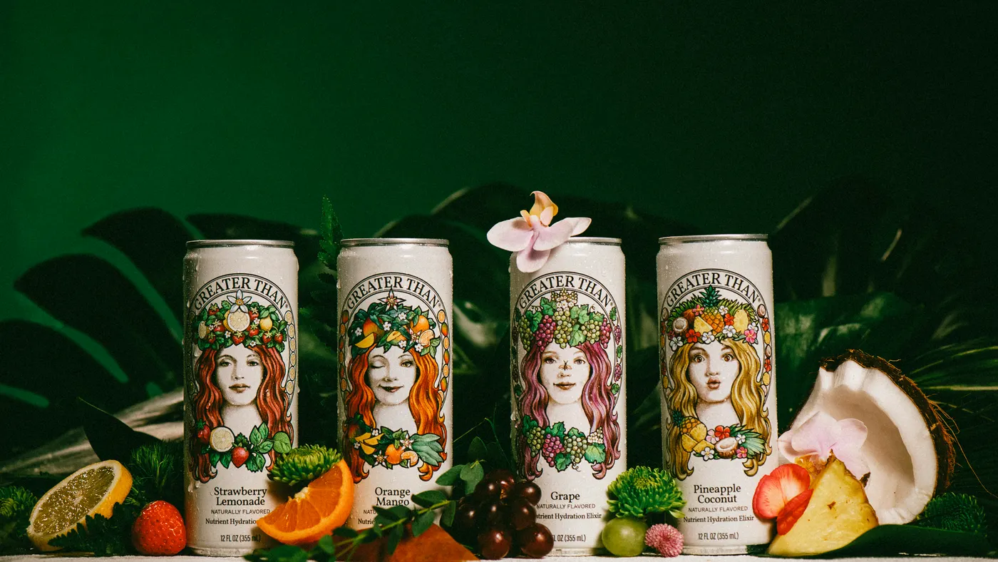 Four cans of Greater Than in different flavors are pictured among fruits.