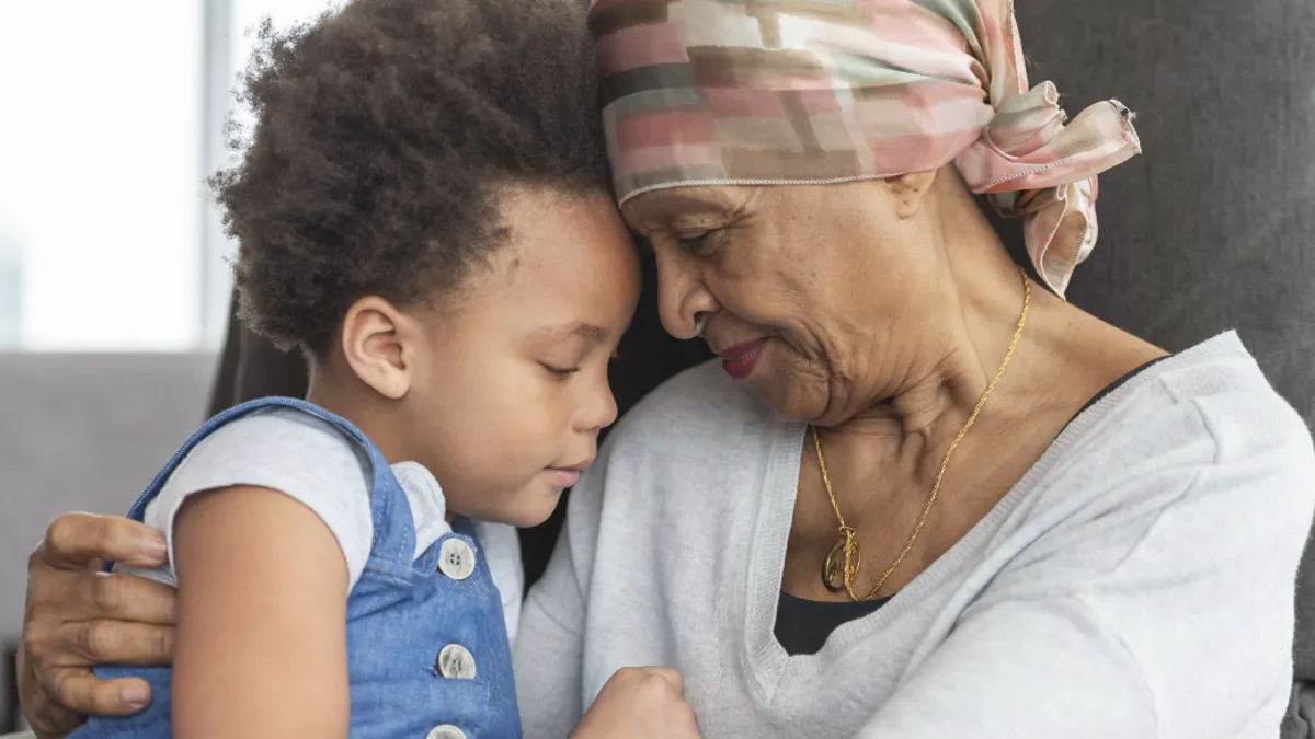 A toddler sitting on an elderly persons lap