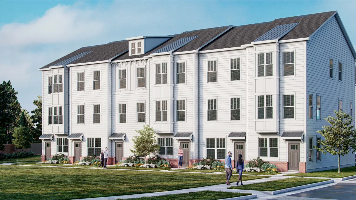 A set of white townhomes with peaked roofs.