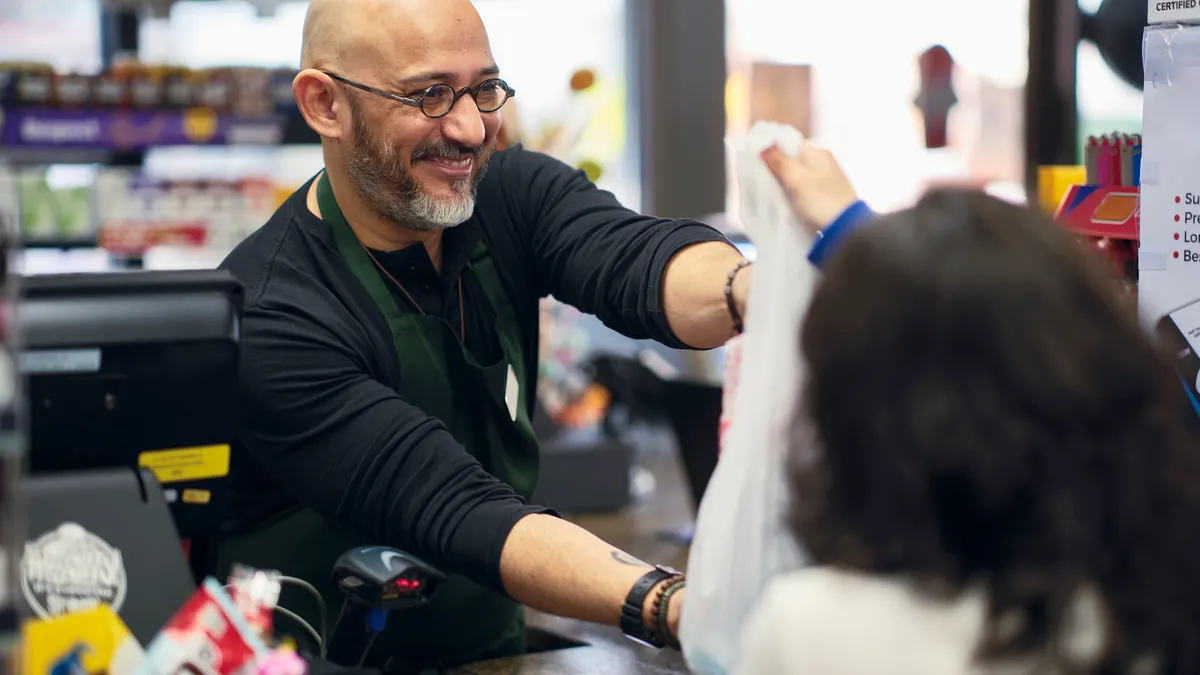 A young couple shopping in a small convenience store.