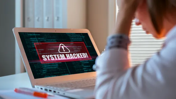 Worried woman looking at laptop.