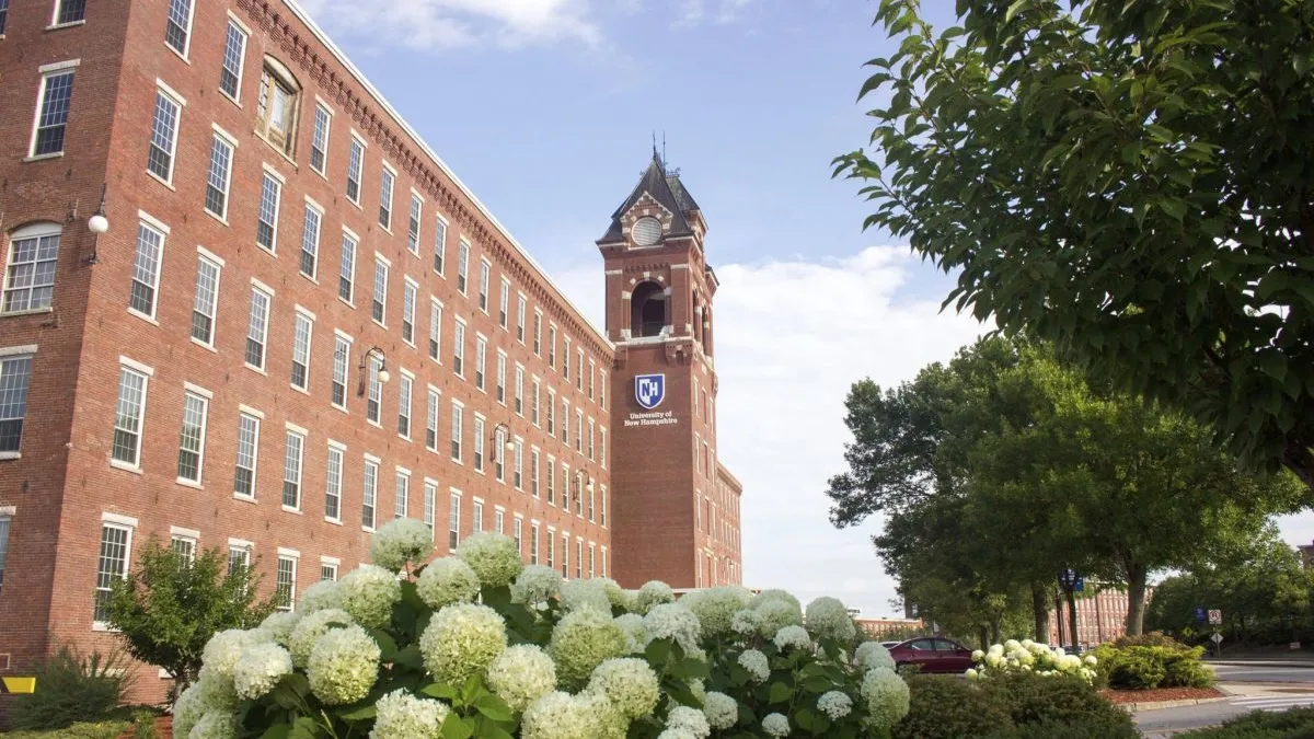 A large brick building with a bell tower on a clear spring day