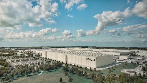 A blue sky and clouds above an artist rendering of the exterior of Toyota's advanced paint facility it plans to build in Kentucky