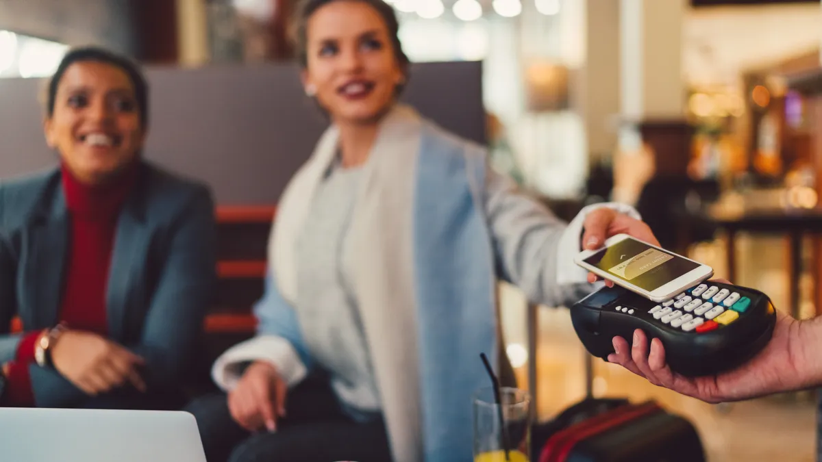 Woman doing contactless payment