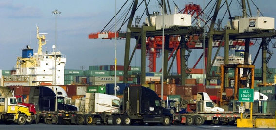 Truck drivers wait in line to pick up shipping containers