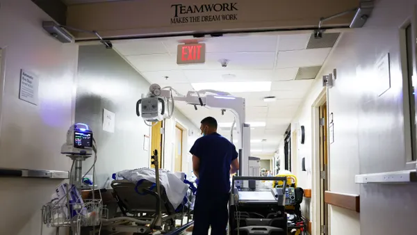 A medical professional tends to a person on a stretcher.