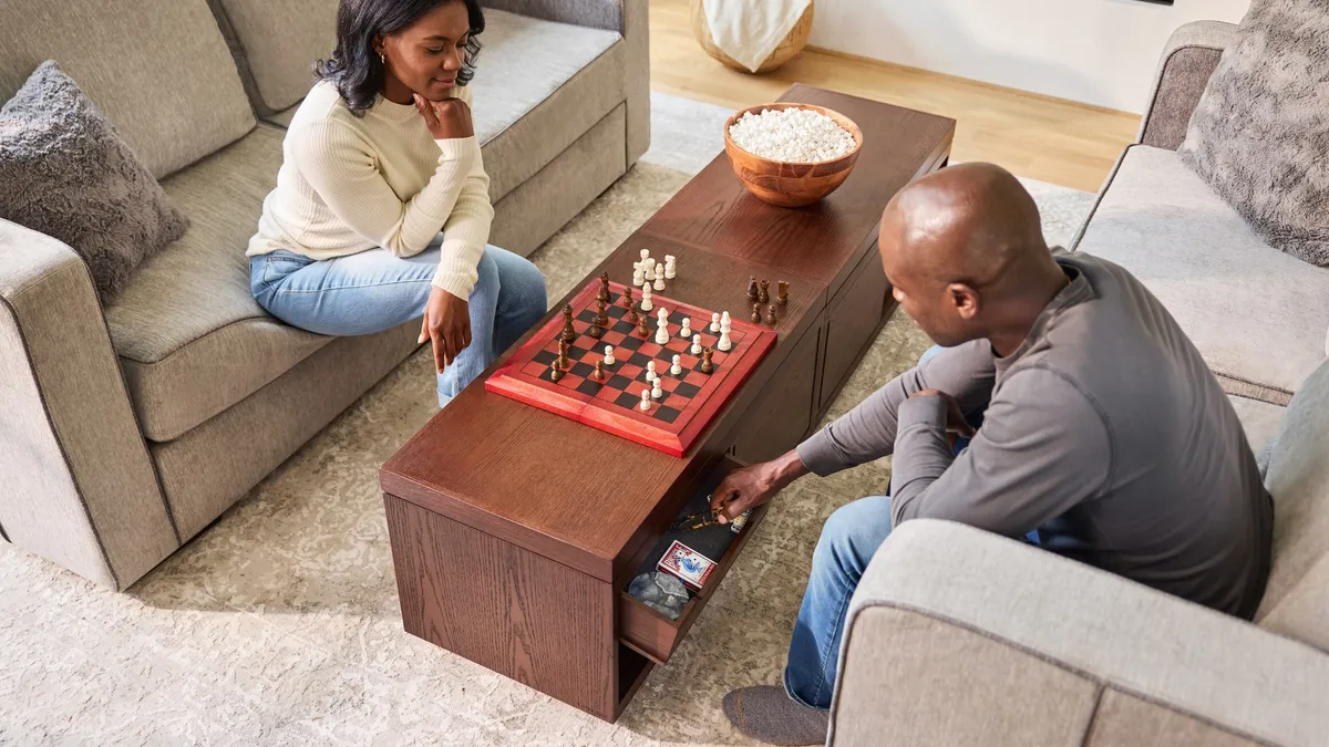 Two people playing a board game on Lovesac's AnyTable