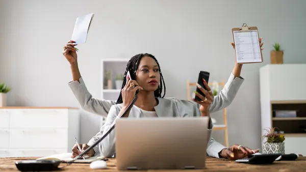 A person works from home with multiple arms sticking out of them