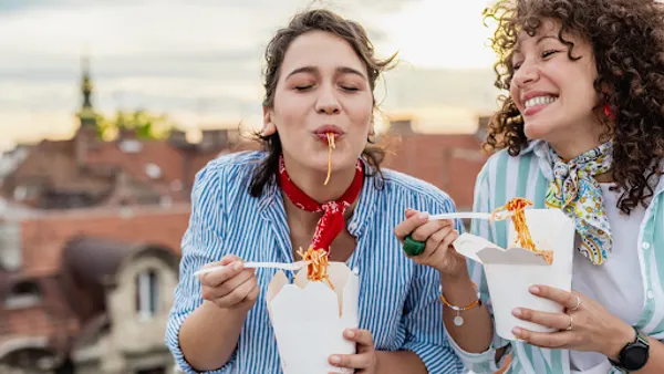 Women eating takeout on a rooftop