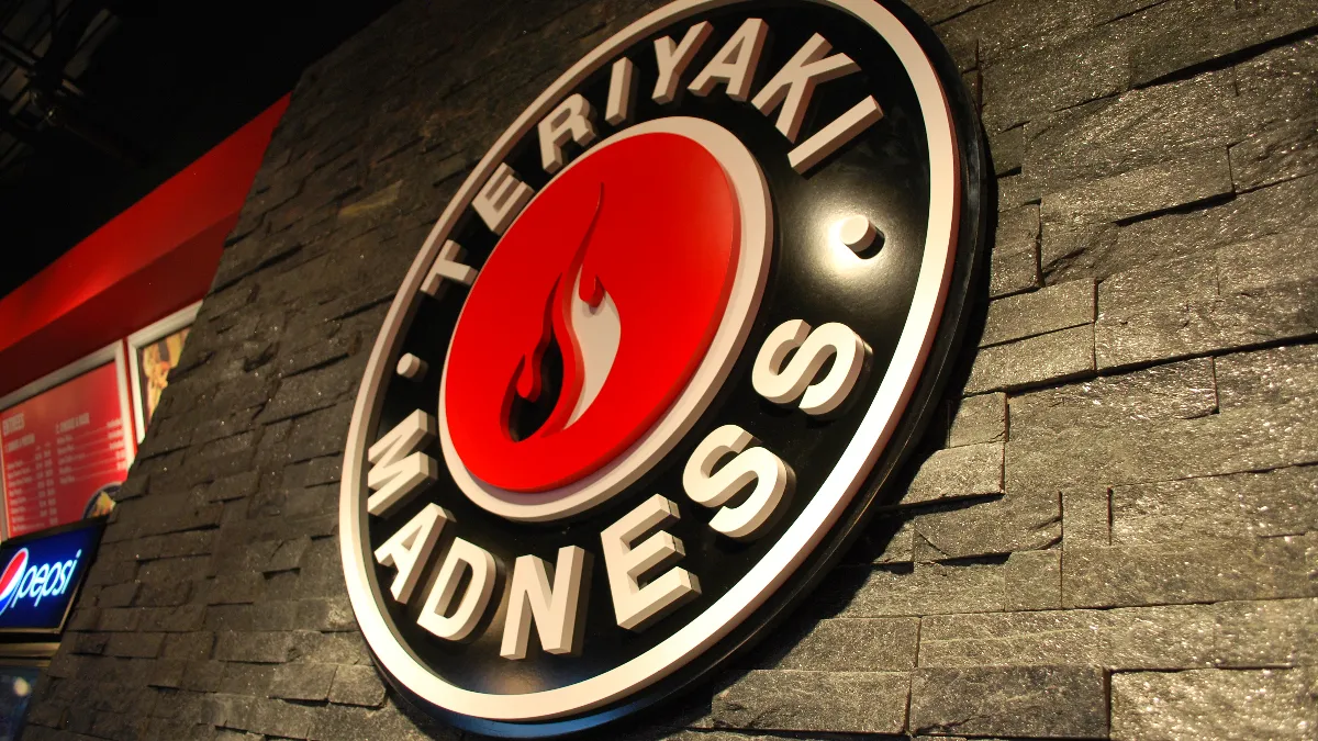 A picture of the Teriyaki Madness logo inside a restaurant