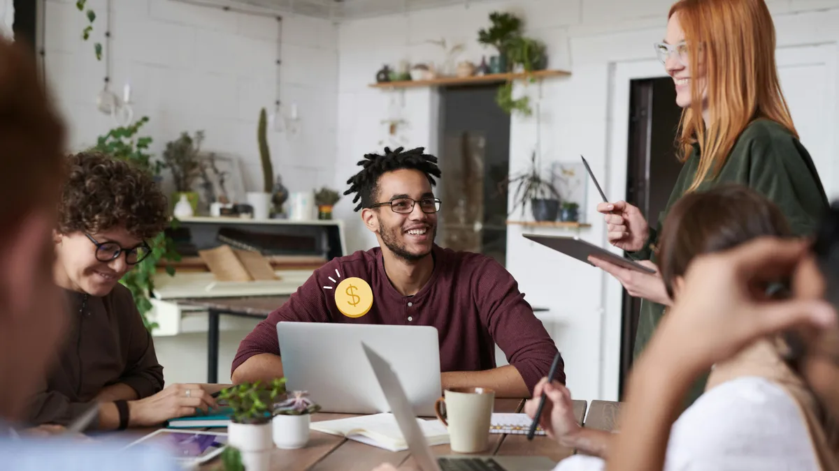 People having a casual meeting at a table with laptops and tablets