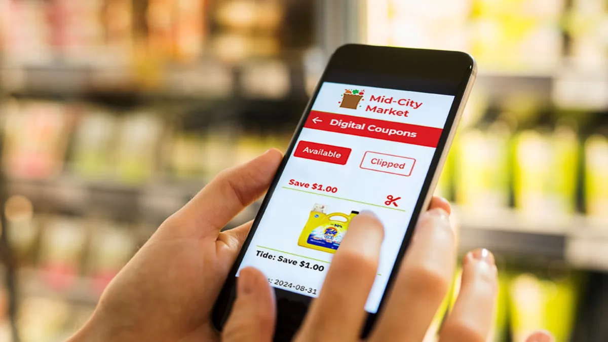 person touching phone in grocery aisle