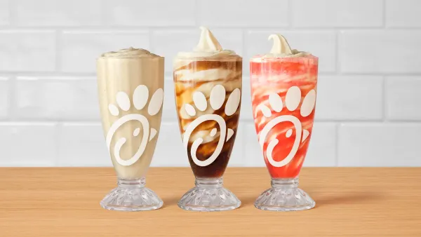 A frosted soda and two floats from Chick-fil-A in old-school soda fountain glasses.