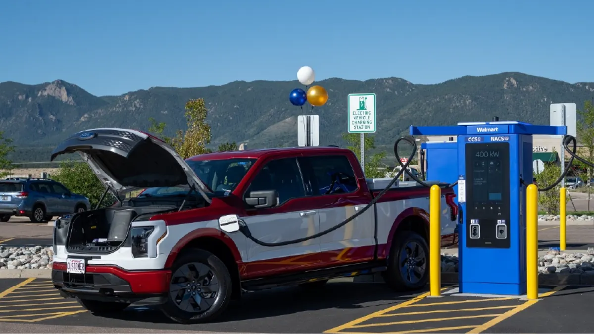 A Ford F-150 Lightning charging at a Walmart Supercenter