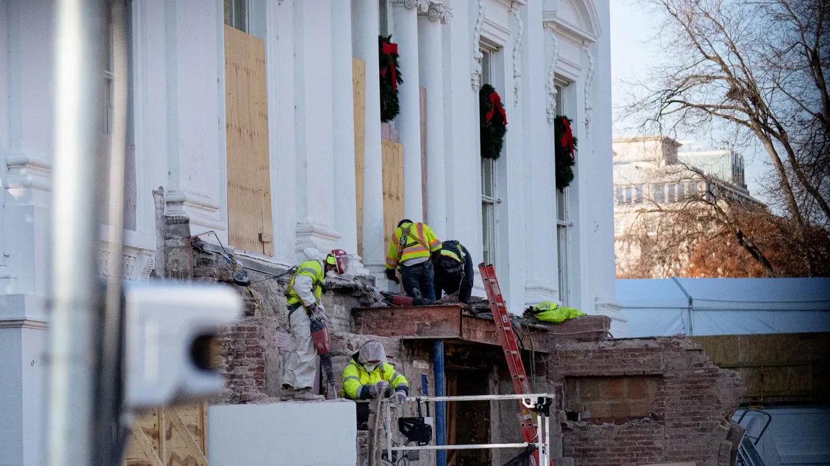Workers continue to work where the East Wing used to connect to the White House